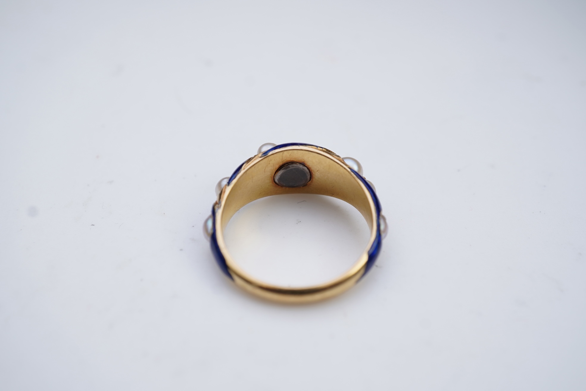 A Victorian half pearl and blue enamel ring, mid 19th century